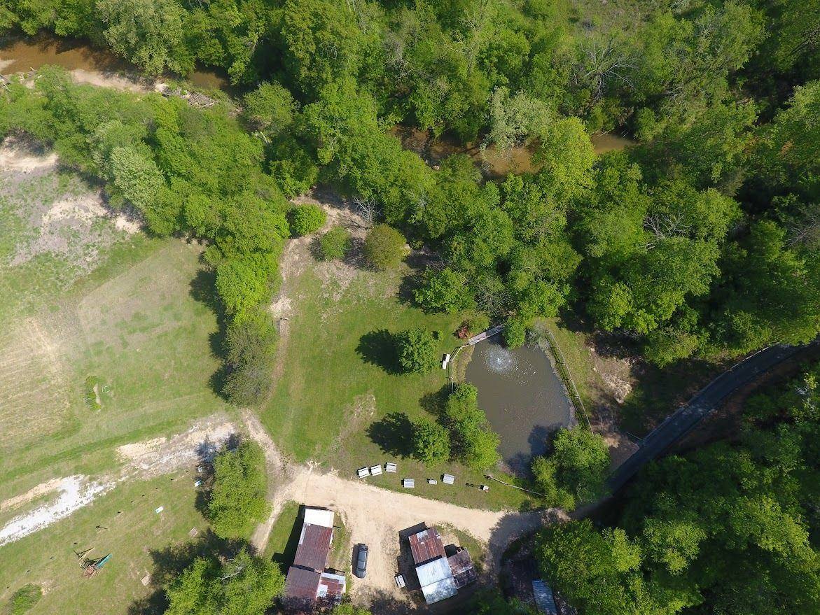Aerial view of Riverside Farm: pond, barns, fields and woods