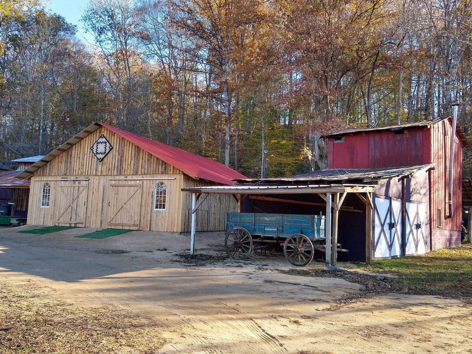 Red-roofed barns and grounds at Riverside Farm in autumn