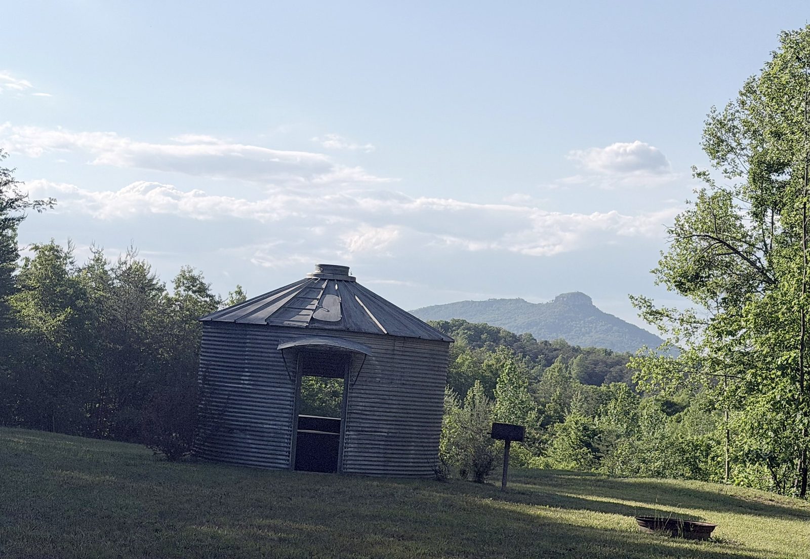 The grain bin with Pilot Mountain in the distance at Riverside Farm Venue
