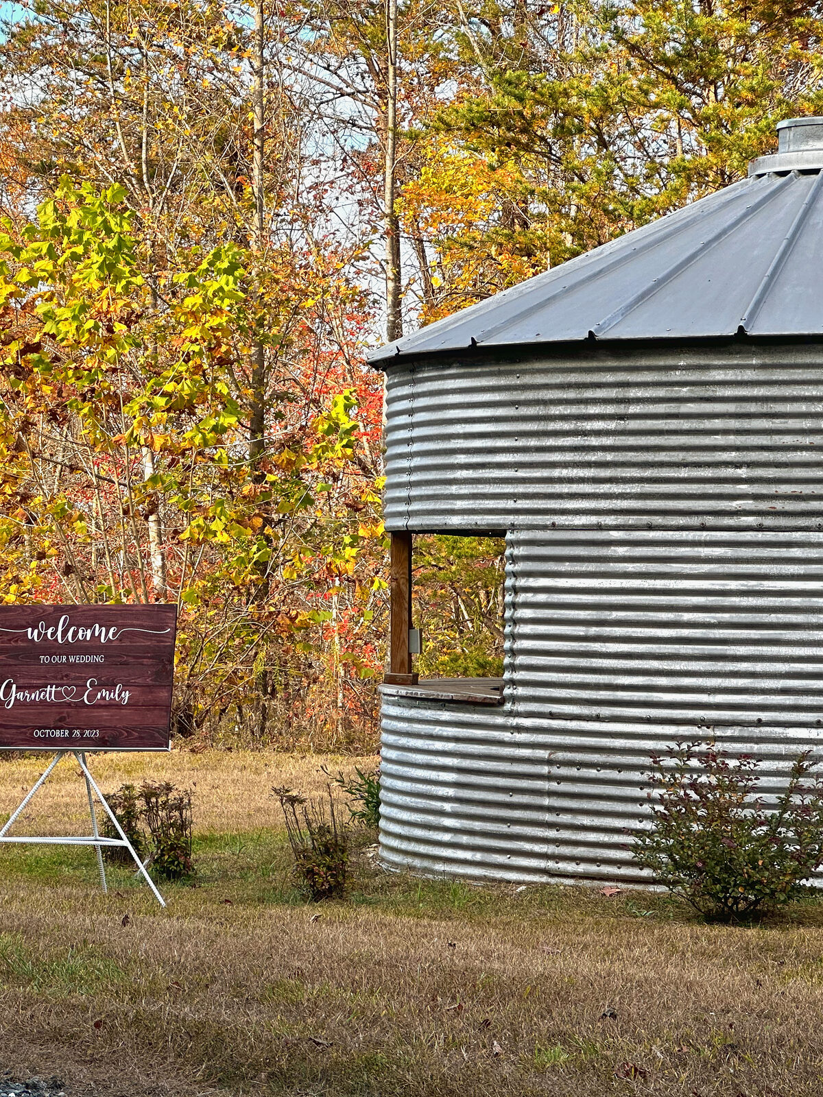 The grain bin with a welcome sign beside it in the fall