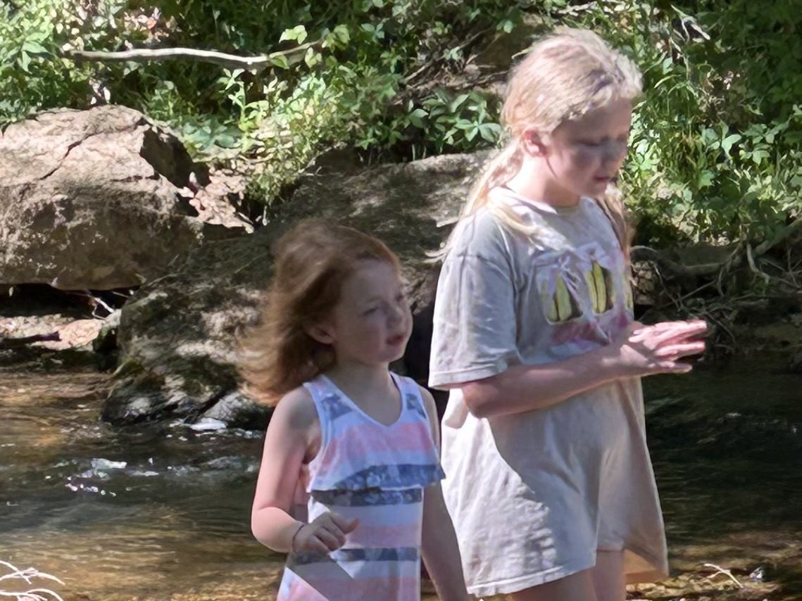 Two girls walking along the Little Yadkin River at Riverside Farm Venue