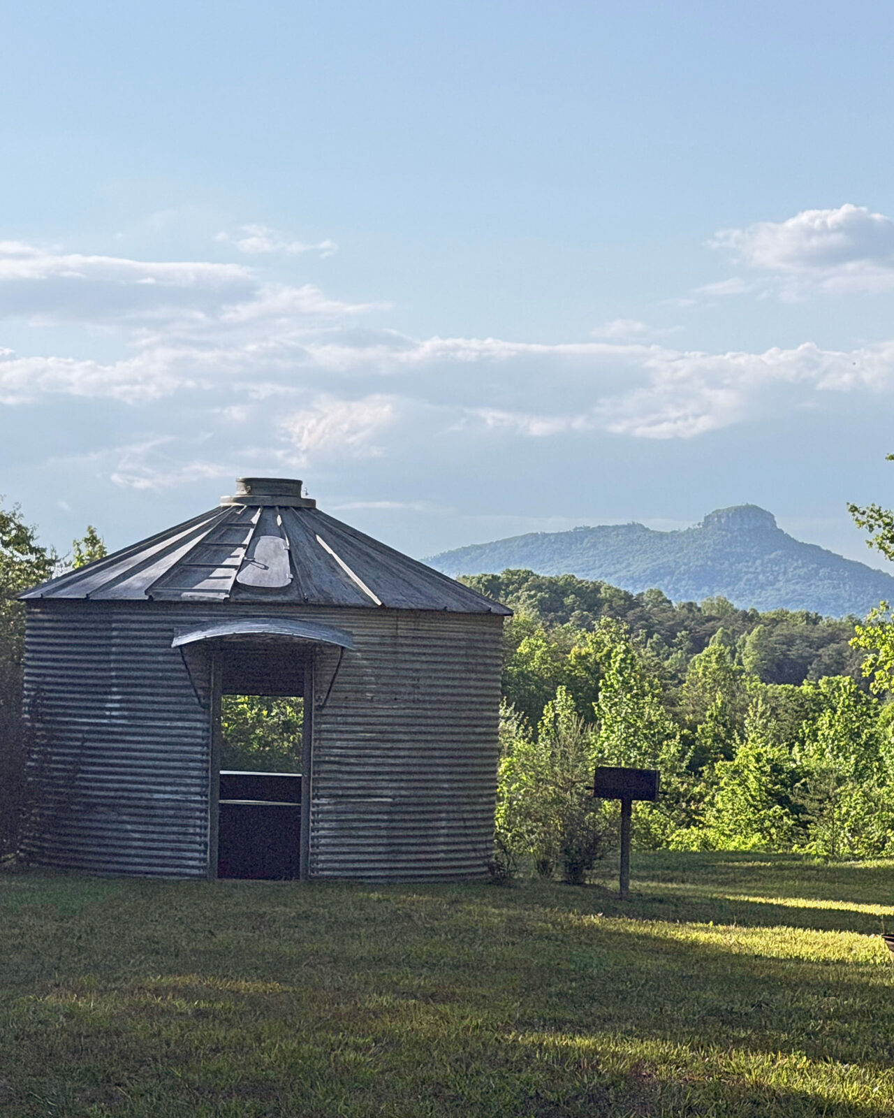 The grain bin with Pilot Mountain in the distance at Riverside Farm Venue